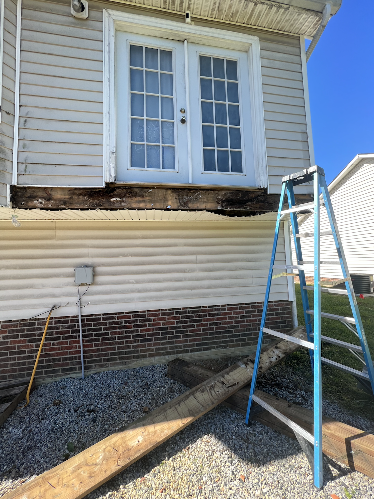 Worn exterior doorway and framing before deck rebuild by Marco's Home Improvement & Remodeling